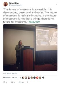 A screenshot of a tweet by the author with an image of her standing behind a podium during her presentation at the conference.